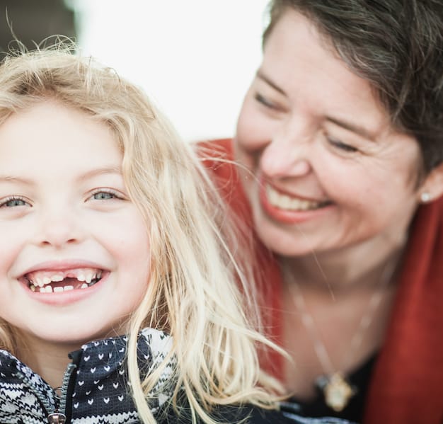 Photo caption: A smiling closeup photo of Julie and her daughter (props to @photographerdaniel)